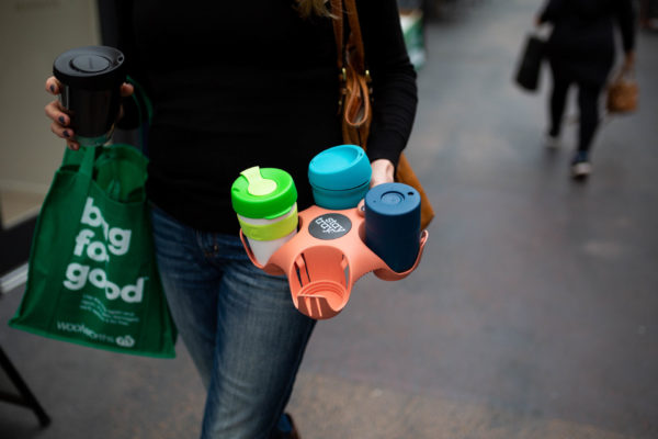 Person carrying reusable coffee tray